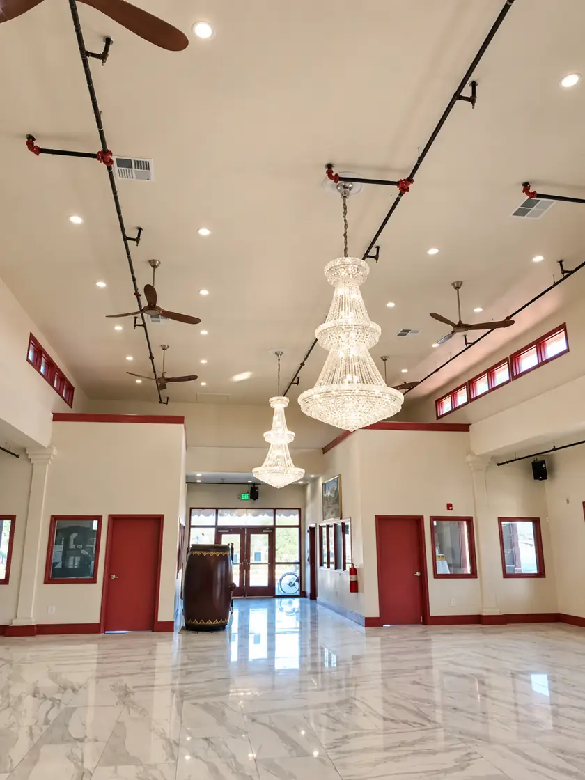 Crystal chandelier and recessed lighting in an event hall