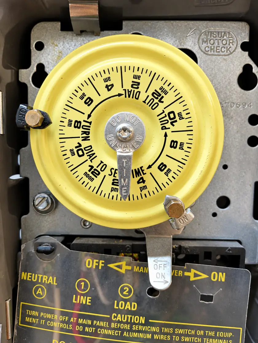Mechanical timer switch that controls outdoor lighting