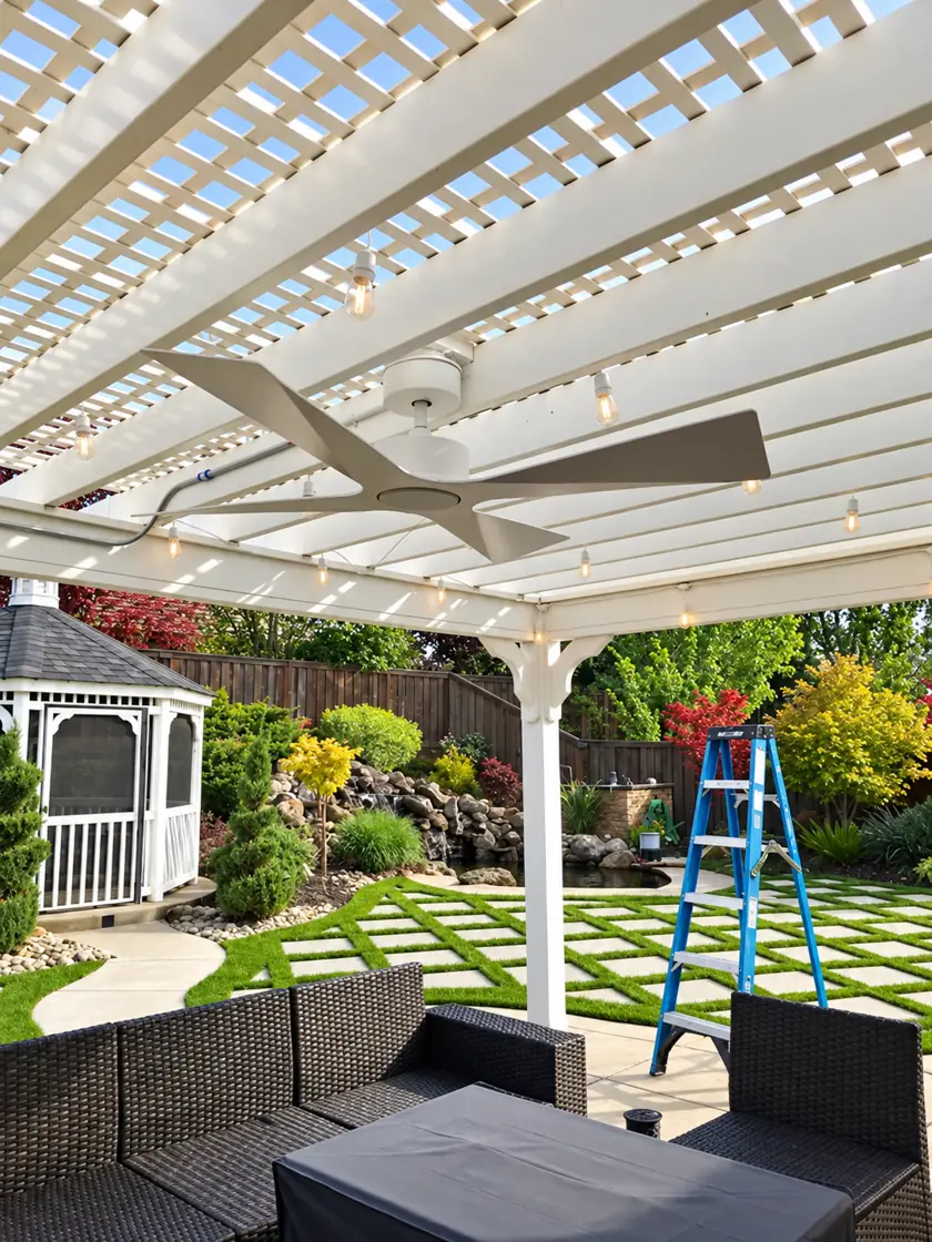 Outdoor ceiling fan mounted under a backyard pergola